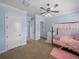 Well-lit bedroom showcases three doors and a view of the four-poster bed with light-colored walls at 7427 20Th St, Zephyrhills, FL 33540