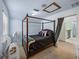 Comfortable bedroom featuring carpet flooring, a fan, and a four-poster bed at 7427 20Th St, Zephyrhills, FL 33540