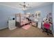 Charming bedroom boasts a four-poster bed, a decorative rug, and an adorable vanity at 7427 20Th St, Zephyrhills, FL 33540