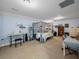 Spacious bedroom with bed, desk, and keyboard at 7427 20Th St, Zephyrhills, FL 33540
