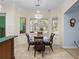 A bright breakfast nook is surrounded by windows and offers backyard views with seating for five at 7427 20Th St, Zephyrhills, FL 33540