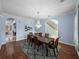 Elegant dining room boasting hardwood floors, chandelier, and views into other living spaces at 7427 20Th St, Zephyrhills, FL 33540