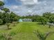Expansive front yard of this estate home features lush landscaping and mature trees for added privacy at 7427 20Th St, Zephyrhills, FL 33540