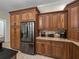 The kitchen features a stainless steel refrigerator, wood cabinets, and granite countertops at 7427 20Th St, Zephyrhills, FL 33540
