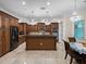 Gourmet kitchen with dark wood cabinetry, granite countertops, and a central island at 7427 20Th St, Zephyrhills, FL 33540