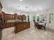 Well-appointed kitchen with wooden cabinets, an island, and adjacent dining area with natural light at 7427 20Th St, Zephyrhills, FL 33540