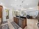 An open-concept kitchen with tile floors features an island with a sink and views to the living areas at 7427 20Th St, Zephyrhills, FL 33540