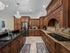 A view of the kitchen features granite countertops, stainless steel appliances, and wood cabinets at 7427 20Th St, Zephyrhills, FL 33540