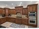 The kitchen offers wood cabinets, granite countertops, and stainless steel microwave and oven at 7427 20Th St, Zephyrhills, FL 33540
