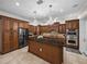 A beautiful kitchen features granite countertops, an island with chandeliers, and wood cabinets at 7427 20Th St, Zephyrhills, FL 33540