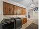 A beautifully designed laundry room with custom cabinetry and modern appliances at 7427 20Th St, Zephyrhills, FL 33540