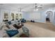 Comfortable living room showcasing a sectional sofa, large screen, and outdoor access at 7427 20Th St, Zephyrhills, FL 33540