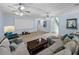 Expansive living room with ample seating, a large screen, and views of the staircase and hallway at 7427 20Th St, Zephyrhills, FL 33540