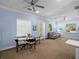 Bright living room features a ceiling fan, comfortable seating, and a glass table with seating for four at 7427 20Th St, Zephyrhills, FL 33540