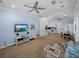 Spacious living area featuring a modern TV, inviting seating, and an open flow to the kitchen at 7427 20Th St, Zephyrhills, FL 33540