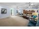 Bright living room with stylish decor, including a peacock-themed painting and kitchen access at 7427 20Th St, Zephyrhills, FL 33540