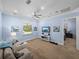 Comfortable living room boasting a large TV, cozy sofa, and seamless access to the bedroom at 7427 20Th St, Zephyrhills, FL 33540
