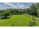 Expansive lot with lush green lawn and mature trees, offering ample space and natural beauty at 7427 20Th St, Zephyrhills, FL 33540