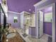 Modern main bathroom featuring double sinks, a walk-in shower, and purple accents at 7427 20Th St, Zephyrhills, FL 33540
