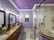 Modern main bathroom featuring double sinks, a walk-in shower, and sleek fixtures at 7427 20Th St, Zephyrhills, FL 33540