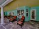 Charming covered patio with comfortable seating, ceiling fans, and easy access to indoor living spaces at 7427 20Th St, Zephyrhills, FL 33540