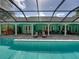 Exterior shot of a full pool featuring a large screened-in enclosure and full patio seating at 7427 20Th St, Zephyrhills, FL 33540