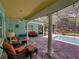 Relaxing screened-in pool area with elegant columns, comfortable seating, and tranquil views at 7427 20Th St, Zephyrhills, FL 33540