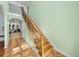 Inviting staircase features decorative metal railings and wood steps leading to the upper level at 7427 20Th St, Zephyrhills, FL 33540