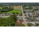 Wide aerial view of a home circled in red, with nearby trees and other houses at 8671 Cypress Lakes Blvd, New Port Richey, FL 34653