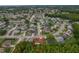 An aerial view showcases the neighborhood surrounding this single-Gathering home with its well-maintained streets and mature trees at 8671 Cypress Lakes Blvd, New Port Richey, FL 34653