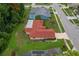 Birds eye view of a home with a well-kept lawn on a quiet street, backing up to lush trees at 8671 Cypress Lakes Blvd, New Port Richey, FL 34653