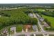 Overhead view of a residence on a corner lot with a red circle around it, on a street lined with trees at 8671 Cypress Lakes Blvd, New Port Richey, FL 34653