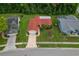 Aerial view of a well-maintained single-story home with a red roof and mature landscaping at 8671 Cypress Lakes Blvd, New Port Richey, FL 34653