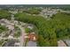 An aerial view showcases the neighborhood surrounding this single-Gathering home with its mature trees and nearby community pool at 8671 Cypress Lakes Blvd, New Port Richey, FL 34653