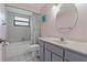 Well-lit bathroom features a shower-tub combo, modern vanity, and oval mirror at 8671 Cypress Lakes Blvd, New Port Richey, FL 34653