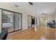 Spacious bonus room with hardwood flooring, natural light, and sliding glass doors at 8671 Cypress Lakes Blvd, New Port Richey, FL 34653