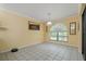 Bright dining room features tile flooring, large window and decorative light fixture at 8671 Cypress Lakes Blvd, New Port Richey, FL 34653