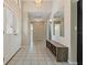Inviting foyer featuring tile floors, neutral paint, and a bench at 8671 Cypress Lakes Blvd, New Port Richey, FL 34653