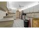 Well-lit kitchen featuring tile floors, stainless steel appliances, and white cabinetry at 8671 Cypress Lakes Blvd, New Port Richey, FL 34653