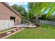 Backyard features a stone fire pit and landscaped seating area at 9206 Brindlewood Dr, Odessa, FL 33556
