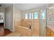 Luxurious walk-in shower with natural light, and soaking tub at 9206 Brindlewood Dr, Odessa, FL 33556