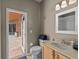 Bright bathroom with modern sink vanity, toilet, and walkout to the pool at 9206 Brindlewood Dr, Odessa, FL 33556