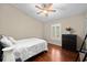 Cozy bedroom features a ceiling fan, hardwood floors, and ample natural light through the window at 9206 Brindlewood Dr, Odessa, FL 33556