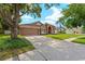 Well-maintained single-Gathering home with a spacious driveway and lush green lawn at 9206 Brindlewood Dr, Odessa, FL 33556