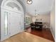 Inviting foyer with a large, arched front door and beautiful hardwood floors lead to dining area at 9206 Brindlewood Dr, Odessa, FL 33556