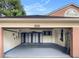 Organized garage featuring gray epoxy floors and ample storage cabinets on the back wall at 9206 Brindlewood Dr, Odessa, FL 33556
