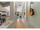 Unique hallway showcases guitars on the wall and offers a glimpse into the kitchen and living spaces at 9206 Brindlewood Dr, Odessa, FL 33556