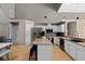 Spacious kitchen featuring white cabinets, stainless steel appliances, and an island with seating at 9206 Brindlewood Dr, Odessa, FL 33556