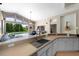 Bright kitchen with a view of the backyard pool and an open layout leading to the living room at 9206 Brindlewood Dr, Odessa, FL 33556