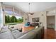 Comfortable living room featuring wood floors, vaulted ceilings, and sliding glass doors to the pool area at 9206 Brindlewood Dr, Odessa, FL 33556